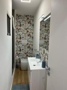 a bathroom with a white sink and a toilet at Home holiday Kalanto in Castellammare del Golfo +63 photos