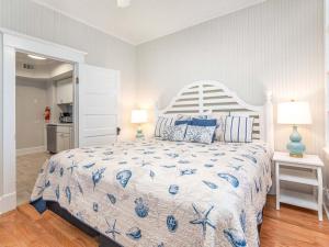 a bedroom with a bed with a blue and white bedspread at Sea View 3 in Tybee Island