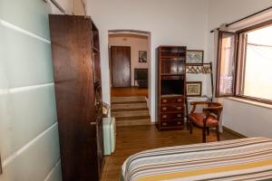 a bedroom with a bed and a chair in a room at Tosti 79 in Formia