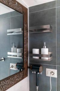 a bathroom with a mirror and a sink at Tosti 79 in Formia +65 photos
