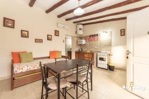 a kitchen and dining room with a table and chairs at Cabañas familiares in Tafí del Valle