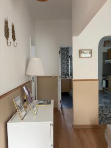 a living room with a table with a lamp at City Break-Quiet House with Private Patio in Torres Vedras