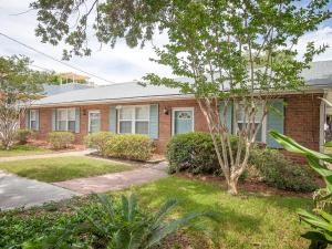 a brick house with a tree in front of it at Latitude Adjustment A in Tybee Island