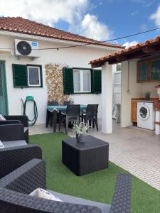 a patio with a table and chairs and a house at City Break-Quiet House with Private Patio in Torres Vedras