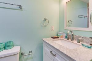 a bathroom with a sink and a mirror at Walk to Beach Coligny Gem with Community Perks! in Hilton Head Island +18 photos