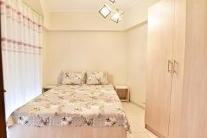 1 dormitorio pequeño con 1 cama y armario en KAVALA The Blue City, en Kavala