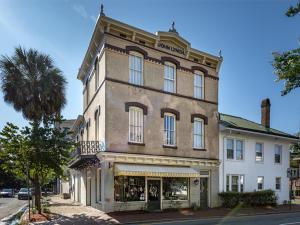 a large brick building with a store on a street at Whitaker By Design in Savannah