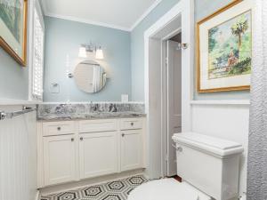 a bathroom with a sink and a toilet and a mirror at Whitaker By Design in Savannah +41 photos