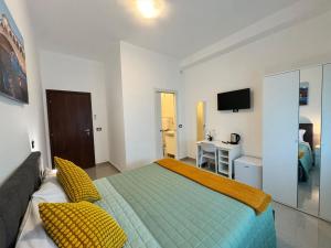 a bedroom with a large bed with yellow pillows at United Apartment in Mestre