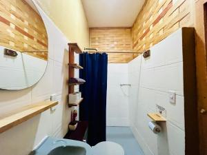 a bathroom with a shower and a blue shower curtain at Palmar la Punta 4 Starlink 2min walk to the beach in Brisas de Zicatela +36 photos
