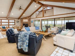 a living room with couches and a table at Sea Gull Ocean Villa in Tybee Island