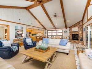 a living room with couches and a table at Sea Gull Ocean Villa in Tybee Island