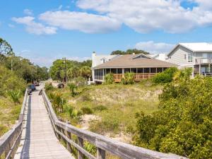 a boardwalk leading to a house on a beach at Sea Gull Ocean Villa in Tybee Island