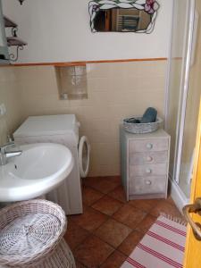 a bathroom with a white sink and a toilet at La Casa delle Meraviglie in Prela' +33 photos
