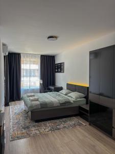 a bedroom with a bed and a large window at Casa Vista Premium 2BR Apartment with Free Parking in Sofia