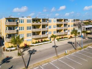 an aerial view of an apartment complex with palm trees at Sandpiper 302 in Tybee Island