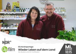 a man and a woman standing behind a counter in a pharmacy at Landidyll Monte Gristow in Mesekenhagen +33 photos