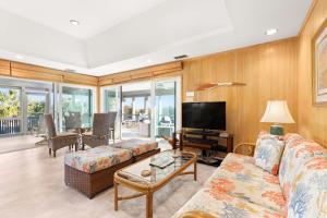 a living room with a couch and a tv at Ocean Walk in Tybee Island