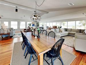 a living room with a wooden table and chairs at Oceanside Unit A in Tybee Island
