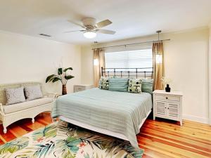 a bedroom with a bed and a couch at Oceanside Unit A in Tybee Island