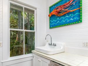 a bathroom with a sink and a window at Ocean Oasis in Tybee Island +56 photos