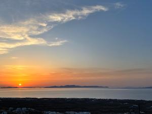 a sunset over a body of water at Sunset Paradise Oia in Oia