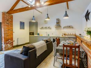a living room with a couch and a table in a kitchen at 1 bed property in York 87323 in Green Hammerton +7 photos