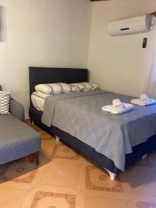 a bedroom with a bed with two towels on it at Arya nature çiftlik in Marmaris