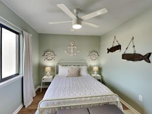 une chambre avec un lit et un ventilateur de plafond dans l'établissement Lighthouse Point 7C, à Tybee Island 18 autres photos