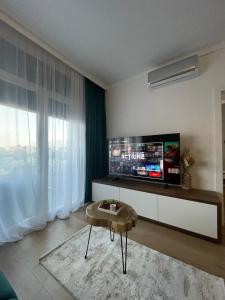 a living room with a flat screen tv on a wall at Apartament Central Arad AFI 2 camere Ared in Arad +68 photos