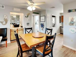 a dining room and kitchen with a wooden table and chairs at Lighthouse Point 20A in Tybee Island