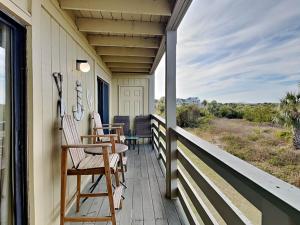 a porch with chairs and tables on a house at Lighthouse Point 20A in Tybee Island