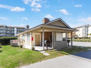 a small house in front of a building at Lighthouse Point 20A in Tybee Island