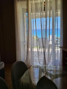 a room with a window with a view of the ocean at Corfu Glyfada Beach Apartment 49 in Corfu
