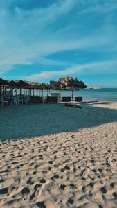 a sandy beach with a view of the ocean at Studio proche de la mer in Calvi +4 photos