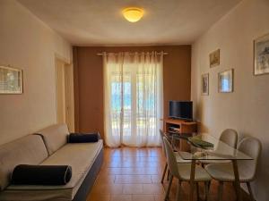 a living room with a couch and a table at Corfu Glyfada Beach Apartment 49 in Corfu +38 photos
