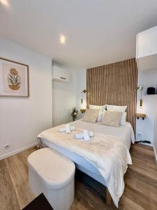 a bedroom with a large bed with a white bedspread at Studio 2 - Cinéma Sport Parking - DABNB in Limoges