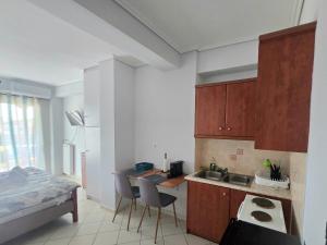 a small kitchen with a desk and a bed at In Centre Suite by Open City in Tripoli