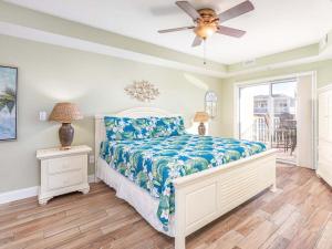 a bedroom with a bed and a ceiling fan at Gull Reef 626 in Tybee Island +33 photos