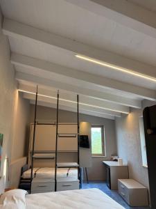 a bedroom with two bunk beds and a desk at Borgo Chimento in San Nicola Arcella