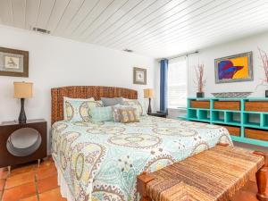 a bedroom with a large bed and a bench in it at Guiding Light Cottage in Tybee Island +52 photos