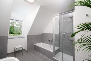 a bathroom with a shower and a bath tub at Gästehaus am Schloss in Schwebheim +47 photos