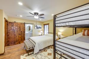 a bedroom with two bunk beds and a ceiling fan at Black Hills Vacation Lodge New Home! Just Opened! in Newcastle