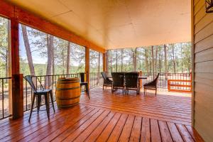 a porch with a table and chairs and a barrel at Black Hills Vacation Lodge New Home! Just Opened! in Newcastle
