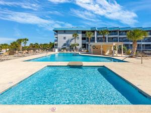 a swimming pool in front of a building at Beach Racquet B202 in Tybee Island