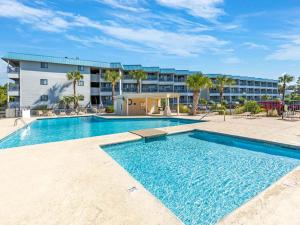 a swimming pool in front of a building at Beach Racquet A301 in Tybee Island