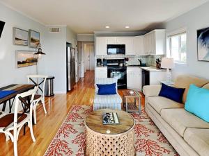 a living room with a couch and a table at Beach Racquet A301 in Tybee Island