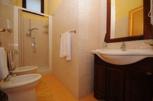 a bathroom with a sink and a toilet and a shower at Residence La Torre Del Sole in Mazara del Vallo