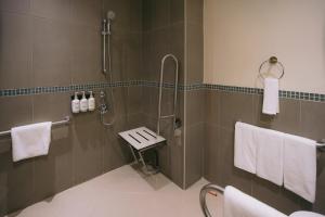 a bathroom with a shower and a sink at Holiday Inn Abu Dhabi by IHG in Abu Dhabi