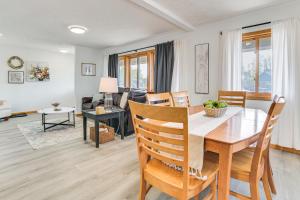 a dining room and living room with a table and chairs at 2 Living Areas! Cedar Home 11 Mi to Mt Holiday Ski in Cedar
